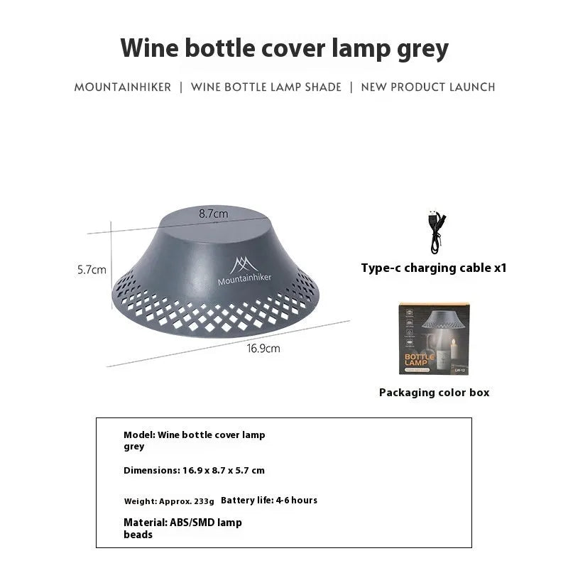 Beige wine bottle shaped camping lantern with USB-C port shown on a table.