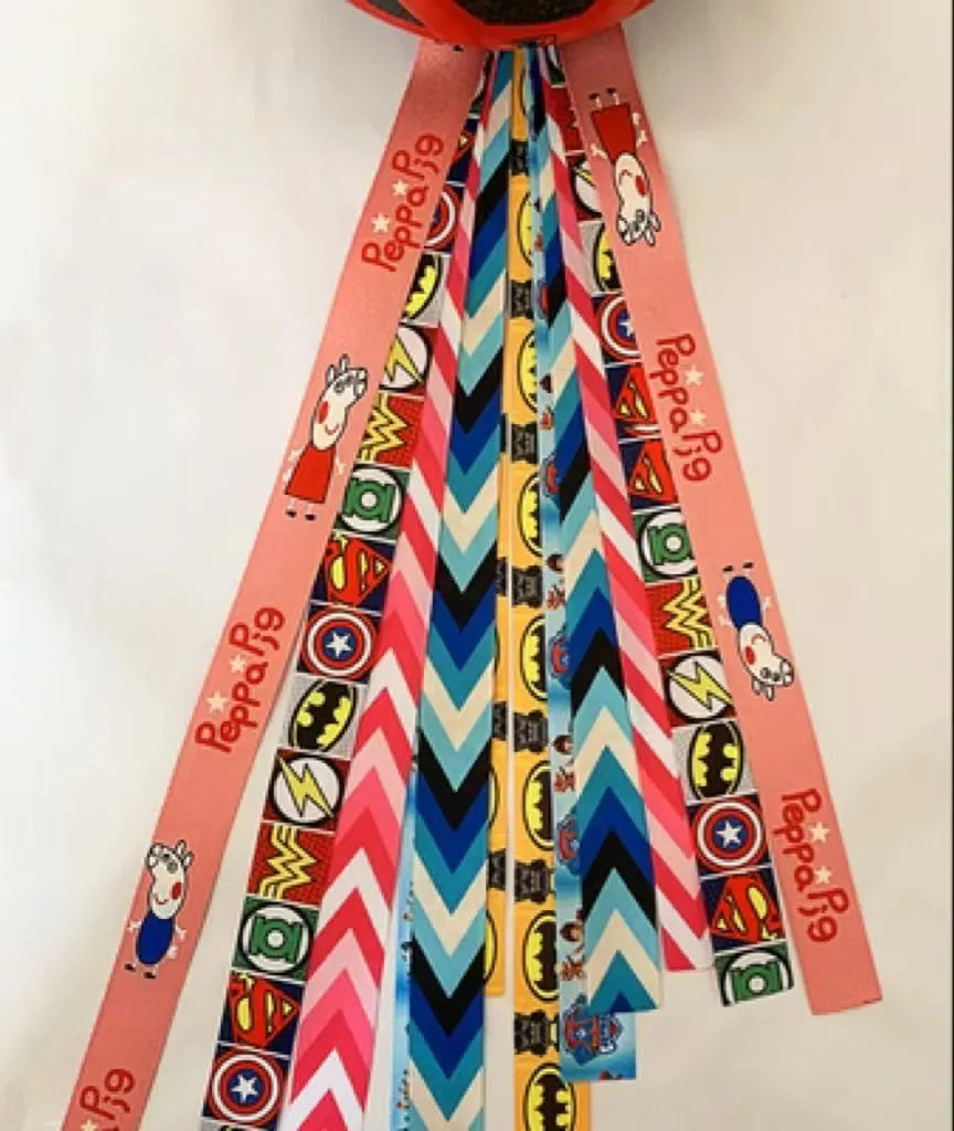 A colourful helmet streamer accessory for children's sports helmets and doll decoration.