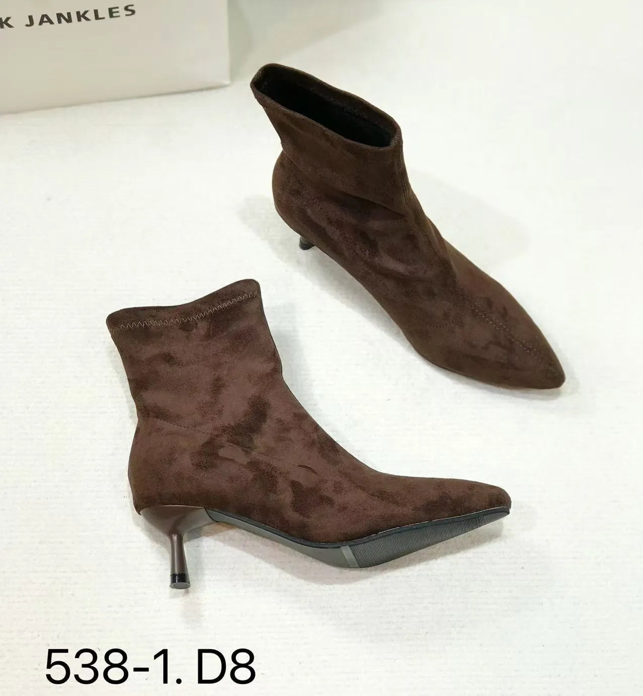 Black pointed toe ankle boots with stiletto heels and mid-calf length