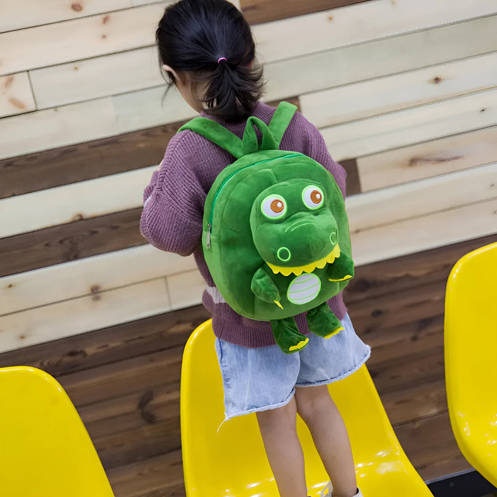 Colourful dinosaur plush backpack for children with soft handle and embroidery detail.