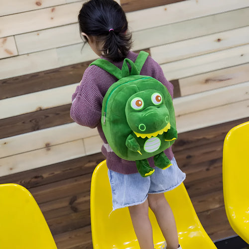 Colourful dinosaur plush backpack for children with soft handle and embroidery detail.