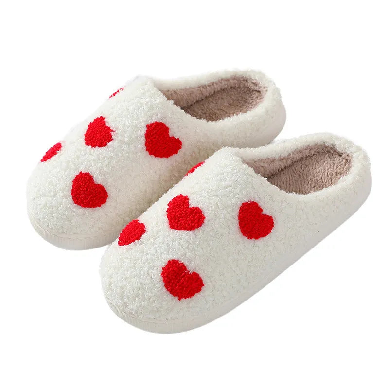 Women's plush cartoon love style home slippers with a non-slip PVC sole.