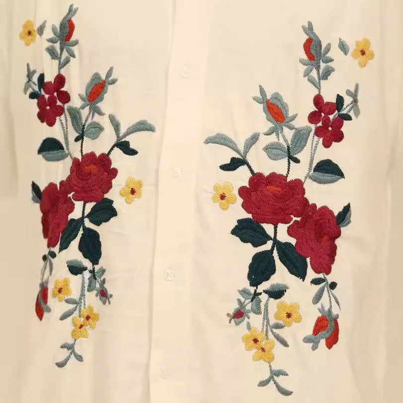 Men's apricot-coloured short-sleeve shirt with vintage floral print and lapel collar on a hanger.