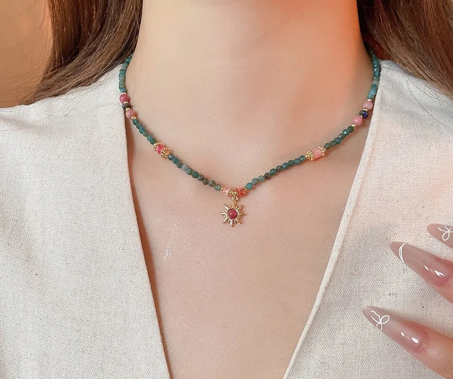 Stone sun pendant and freshwater pearl French court style necklace on a model