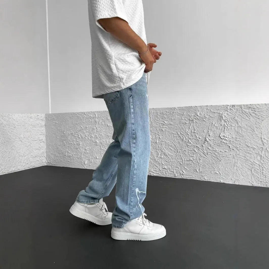 Men's blue straight-leg denim jeans with mid-waist design and loose wide-leg silhouette