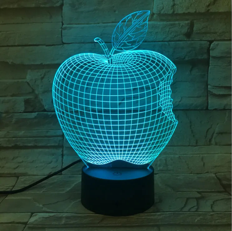 3D fruit-shaped colourful night light with touch controls and acrylic shade on a surface.