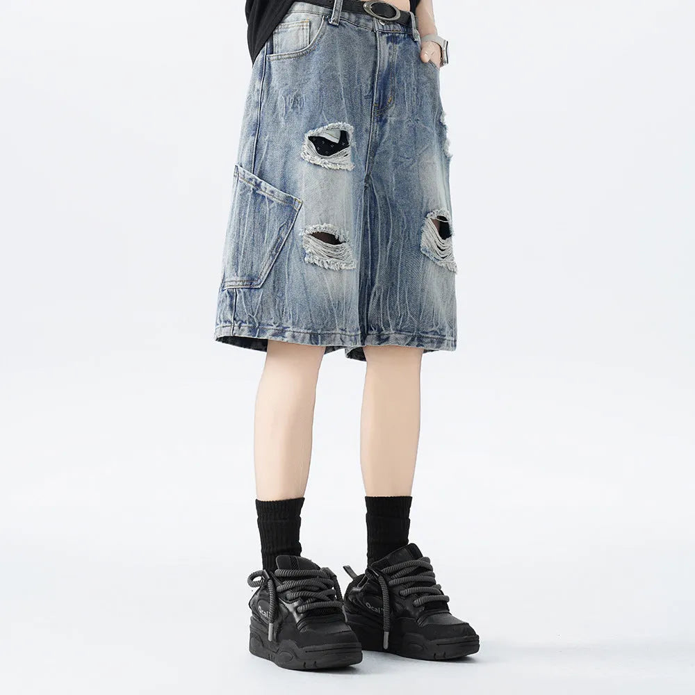 Men's vintage denim shorts with distressed detailing in loose fit design