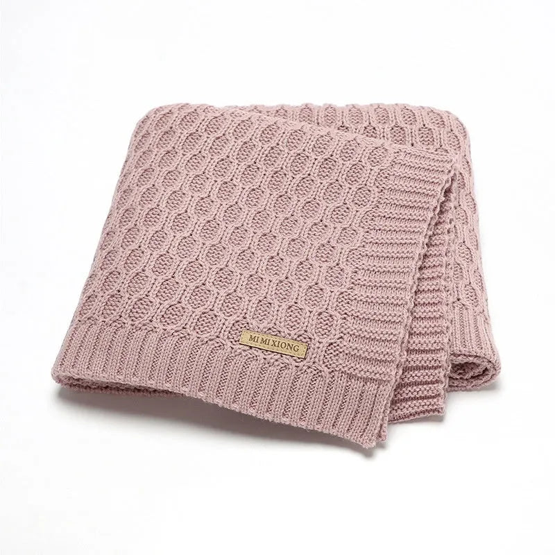 Solid colour acrylic infant hug blanket with textured lines, shown in beige khaki colour.