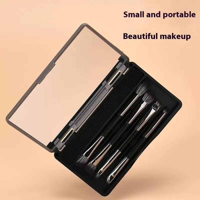 Compact makeup brush set with mirror showing silver or gold finish brushes with artificial fibre heads