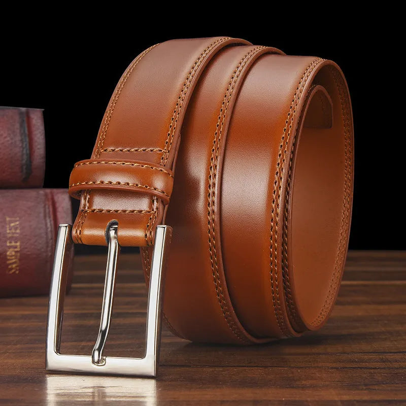 Men's black leather belt with silver alloy pin buckle showing two-layer cowhide construction