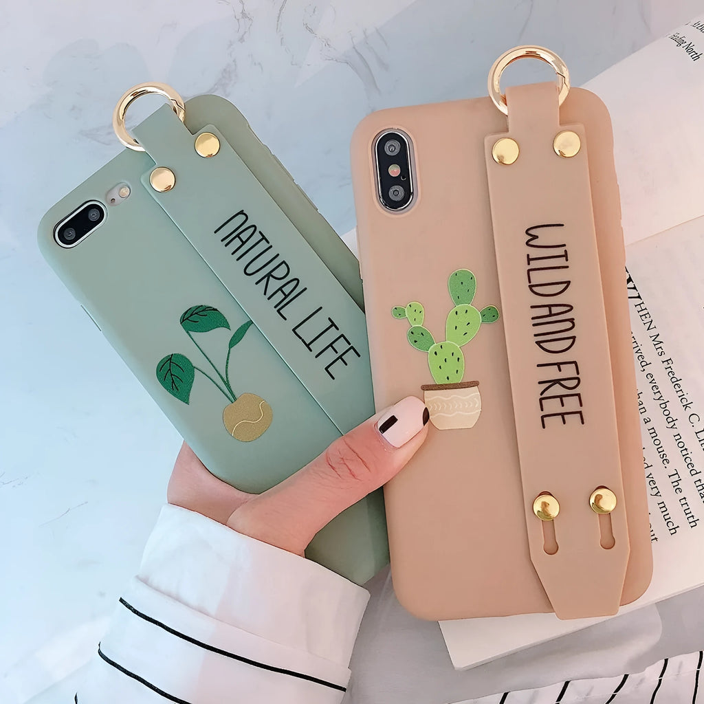 Green wristband holder phone case with graffiti design for iPhone, showing the integrated carrying loop.