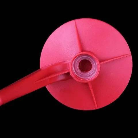 Red plastic Magic Tap soda dispenser attached to 2-litre bottle with push-button tap