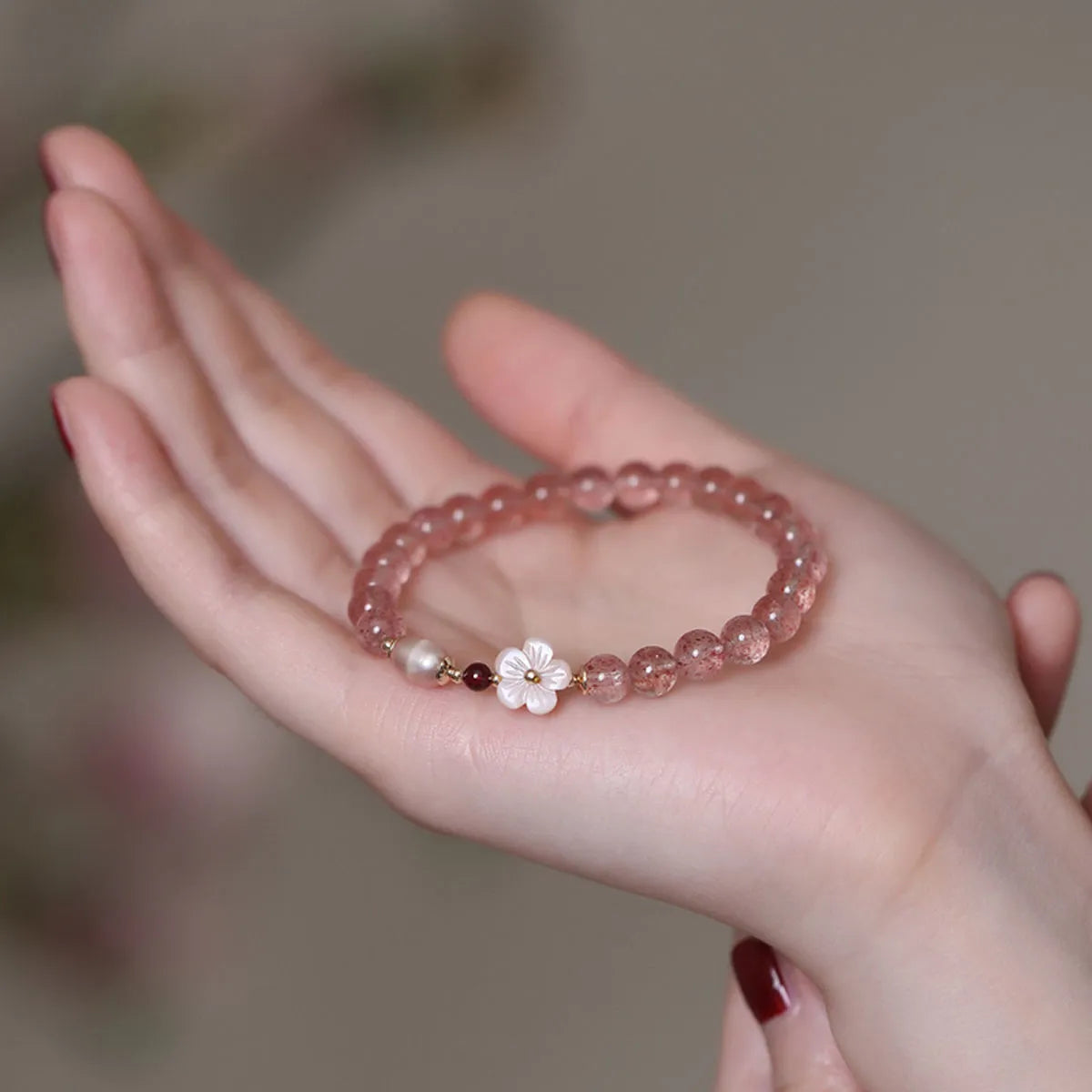 Strawberry quartz peach blossom bracelet with crystal beads and floral charm on adjustable chain