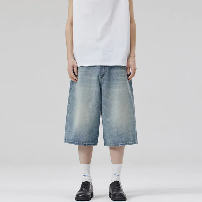 Man wearing straight-leg light blue denim shorts, showcasing the cropped length and loose casual fit.