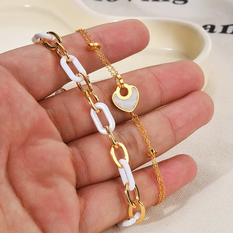 Women's stainless steel bracelet with double-layered resin heart design