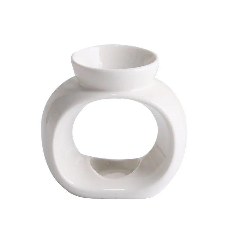 White Nordic minimalist ceramic aromatherapy stove ornament for indoor fragrance diffusion.