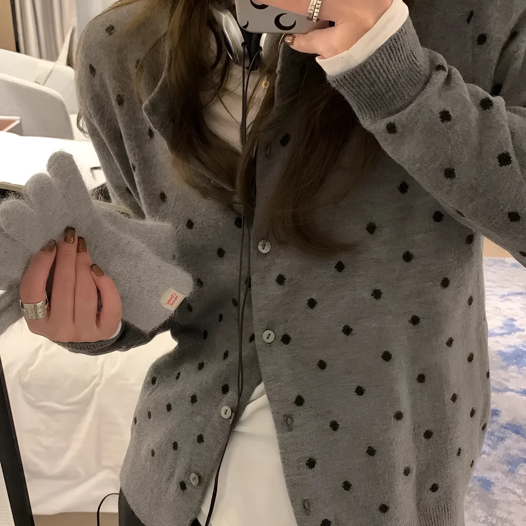 Grey Korean-style knitted cardigan with crocheted flower detail on mannequin