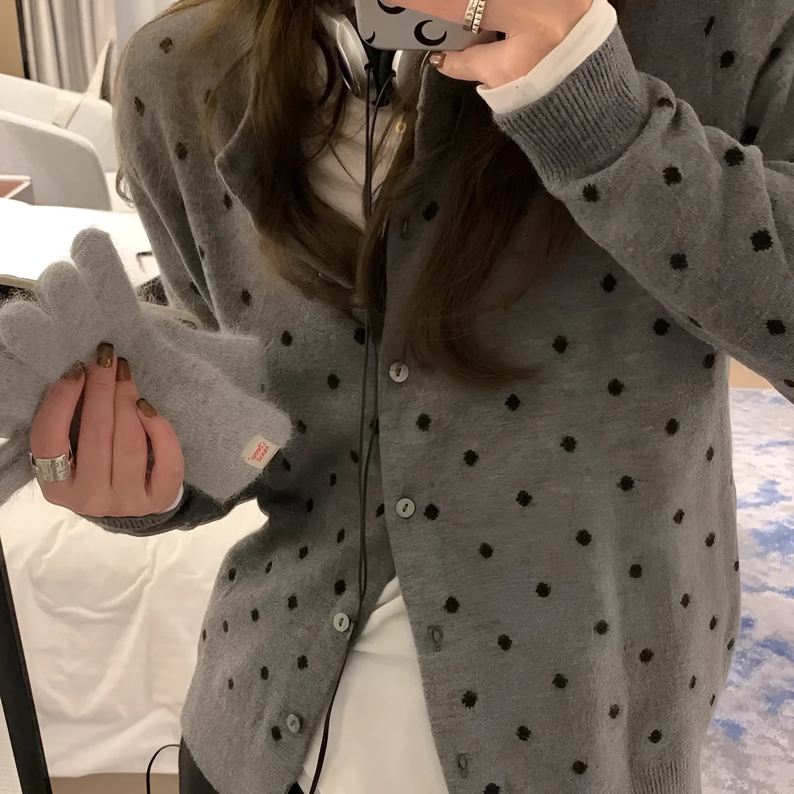 Grey Korean-style knitted cardigan with crocheted flower detail on mannequin