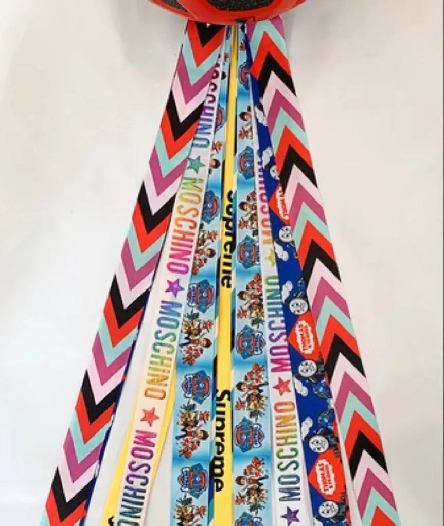 A colourful helmet streamer accessory for children's sports helmets and doll decoration.
