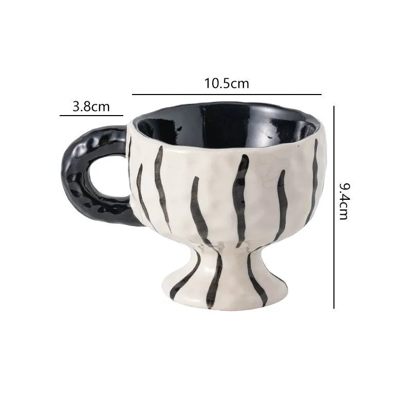 Hand-pinched irregular shaped ceramic mug in solid colour with modern simplicity design