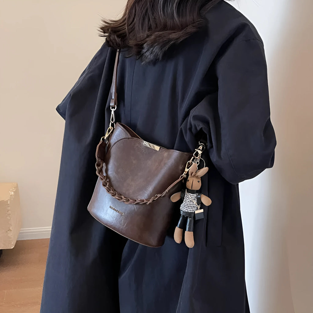 Women's retro bucket messenger bag in PU leather, 21x11x21 cm, with pendant detail and double shoulder strap connector