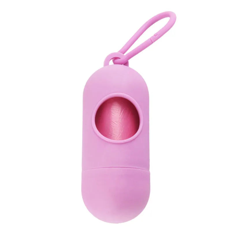 Compact black dog poop bag holder with hook and Velcro strap, shown attached to a pair of trousers.