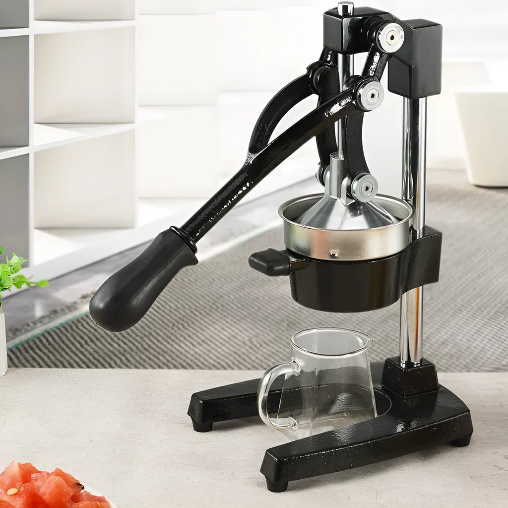 Manual citrus juicer with cast iron base and stainless steel strainer in black or white finish