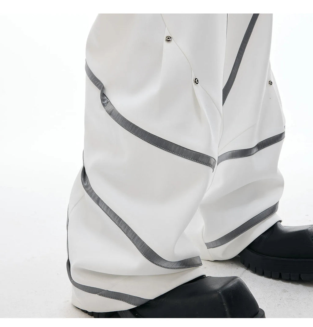 Men's trousers with metal striped rivet pleated design showing three-dimensional cutting detail