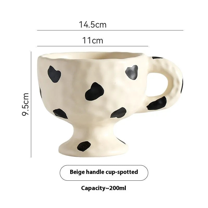 Hand-pinched irregular shaped ceramic mug in solid colour with modern simplicity design