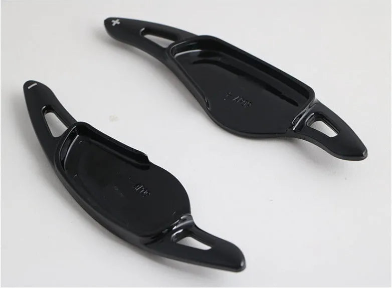 Steering wheel paddle shifter modification kit with carbon fibre pattern on black background