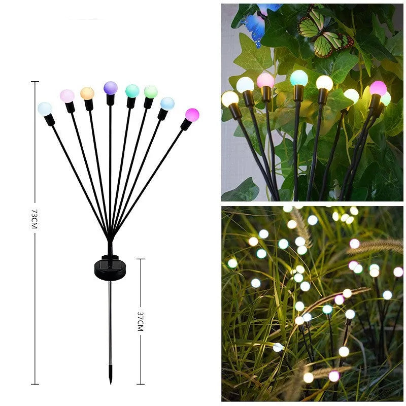 Solar-powered LED firefly lawn light with ground stake inserted in grass