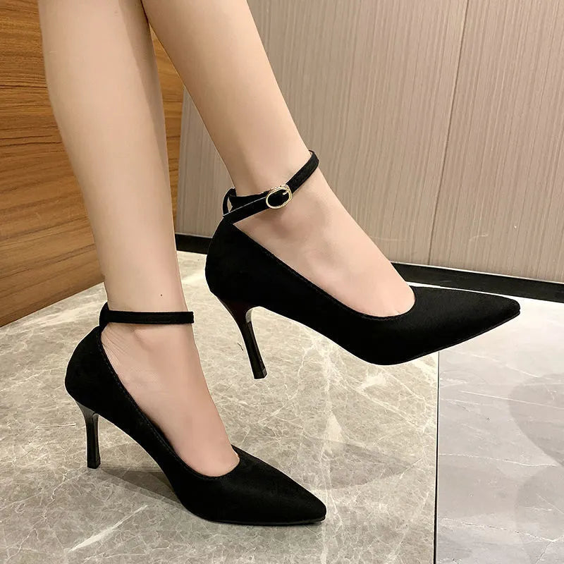 Black women's stiletto heel pump with a buckle detail, shown on a white background.