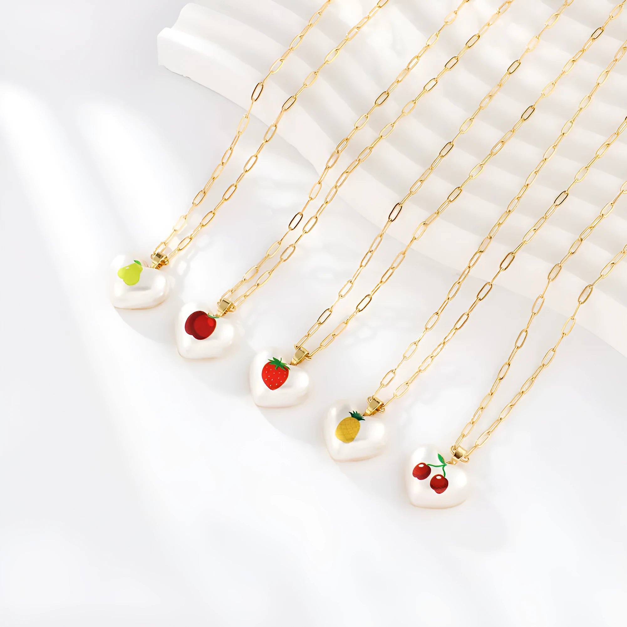 Geometric heart fruit pendant necklace with adjustable chain showing strawberry, pineapple, apple designs