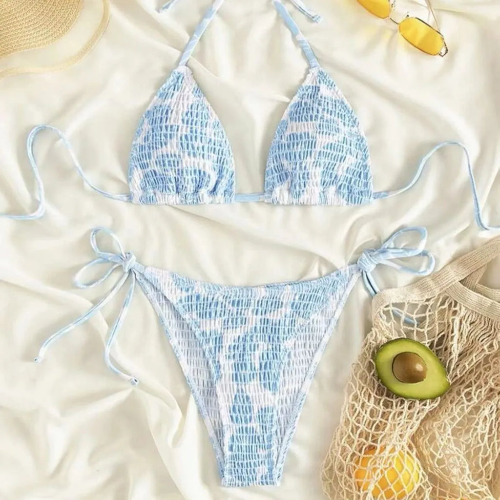 Women's floral print halter neck swimsuit briefs in light blue on a mannequin.