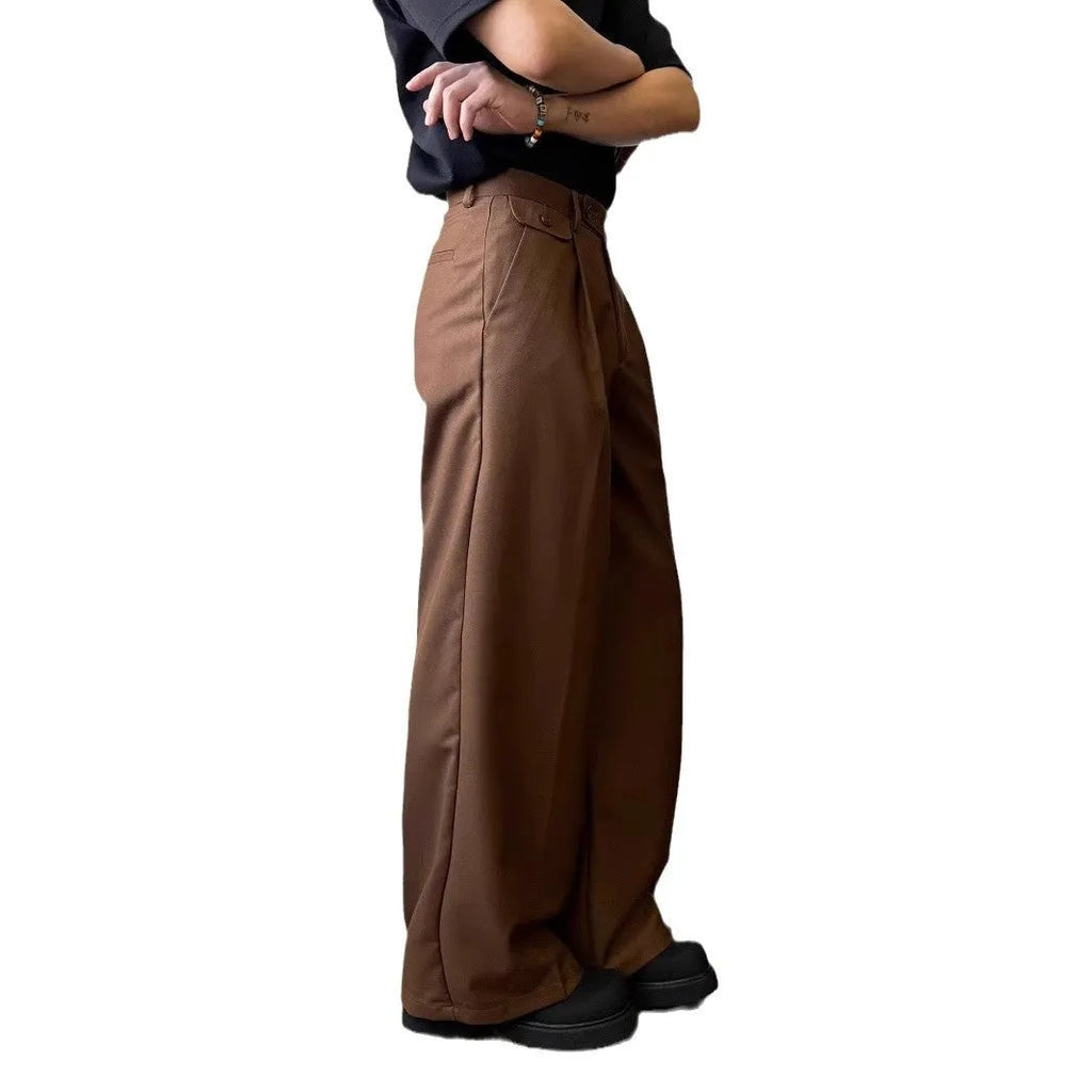 Men's straight-leg loose-fit trousers in brown and black colours on a hanger.