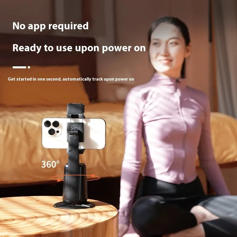 Black desktop phone bracket with LED ribbon lights showing rotating camera head and remote control