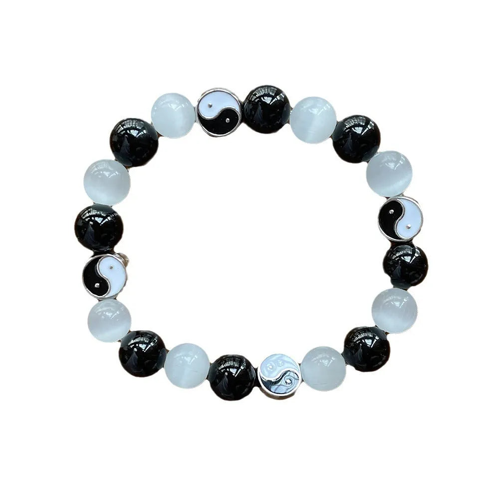 Close-up of a 10mm natural opal and black agate beaded Tai Chi bracelet for men and women.