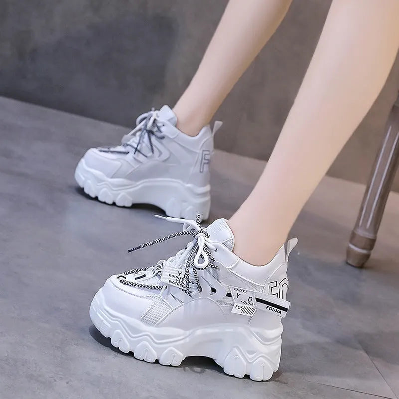 White women's low-top platform sports shoes with breathable mesh, cross strap, and rubber sole.