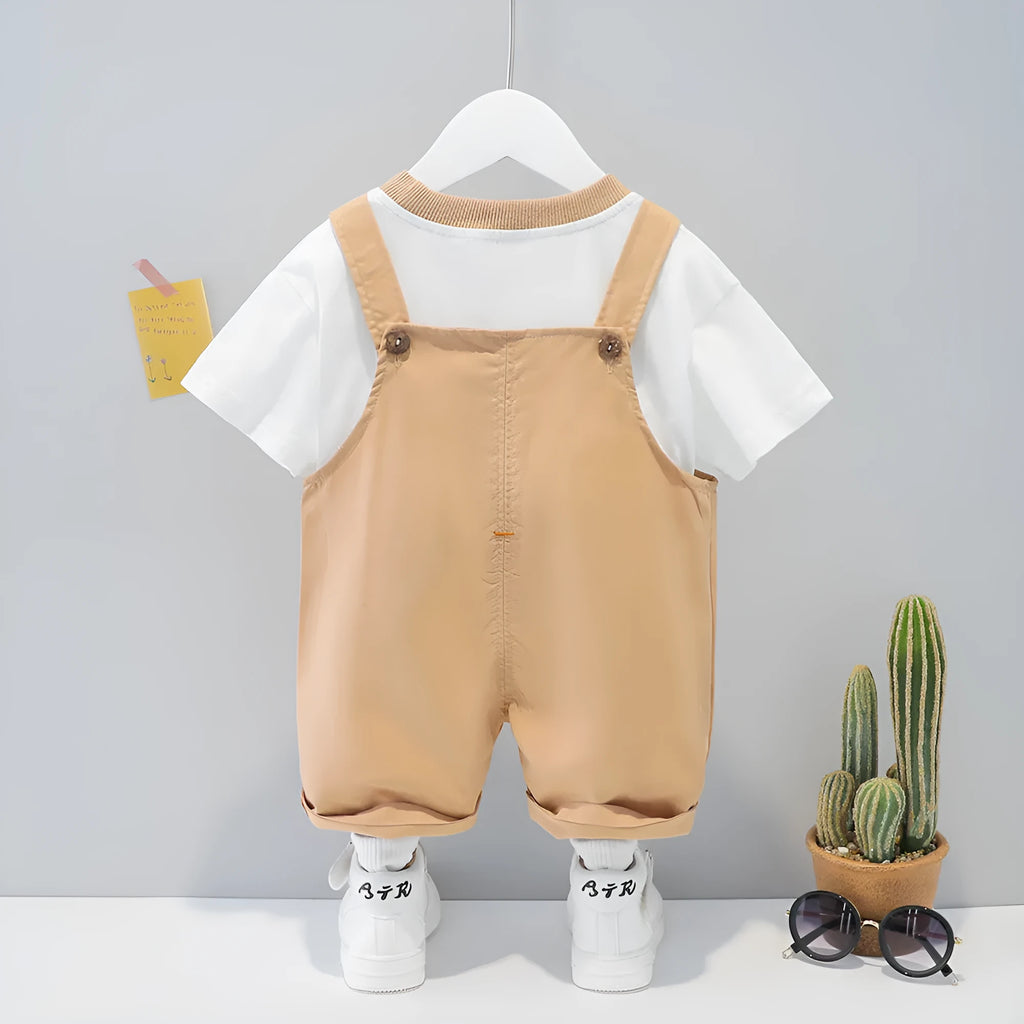 Yellow cartoon print cotton baby overalls with short sleeves and adjustable shoulder straps on a hanger.