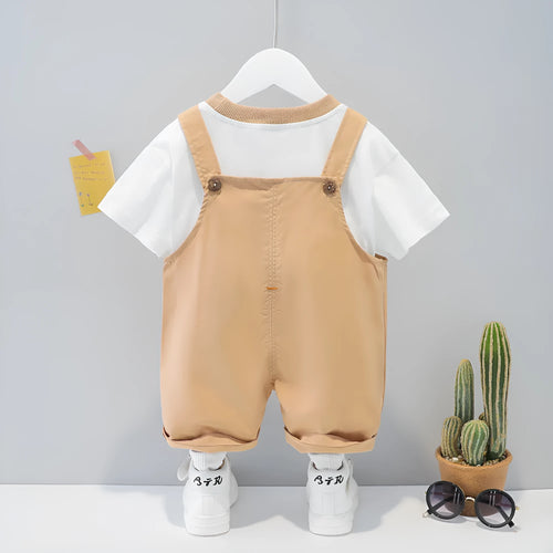 Yellow cartoon print cotton baby overalls with short sleeves and adjustable shoulder straps on a hanger.
