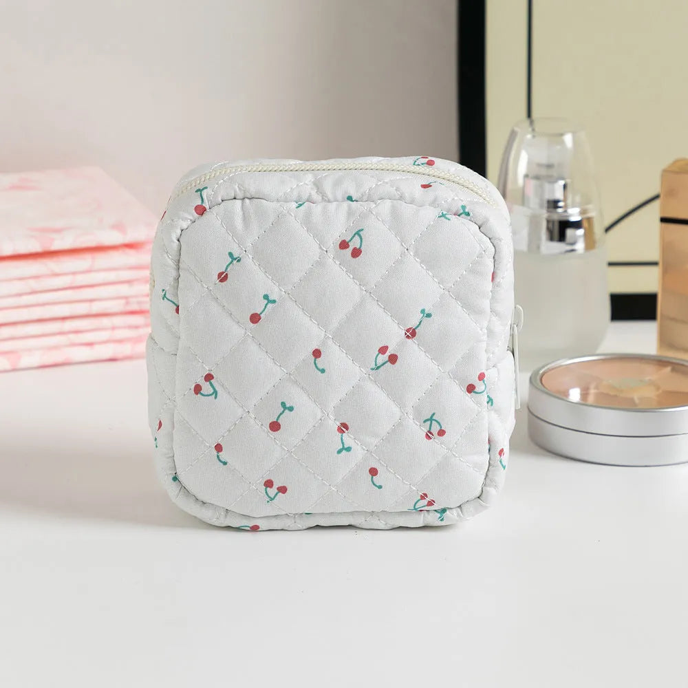 Women's floral patterned polyester key storage bag with sewing thread detail.
