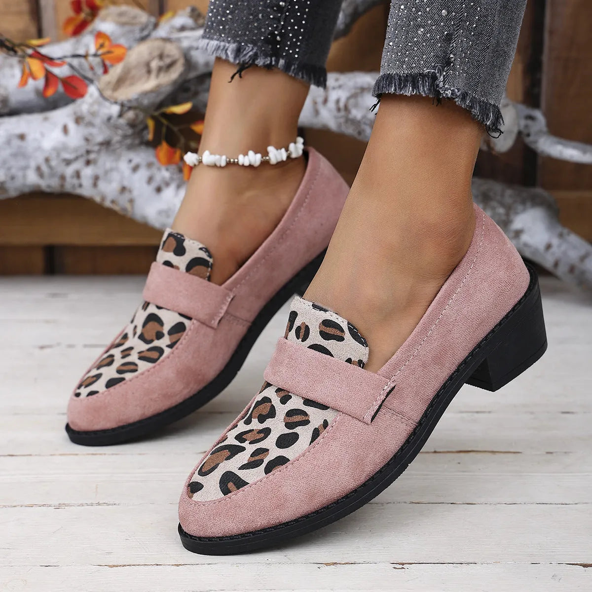 Leopard print suede slip-on pump with chunky heel in brown, shown from the side.