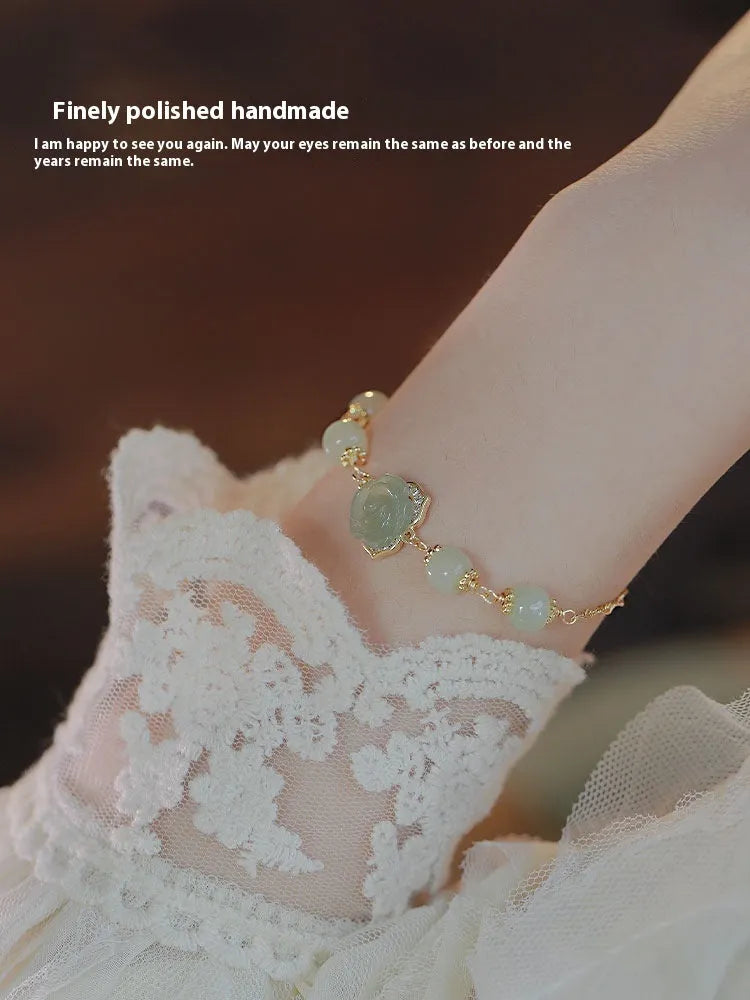 Women's Hetian Jade bracelet with carved rose design and 14K gold gilding on floral-shaped band
