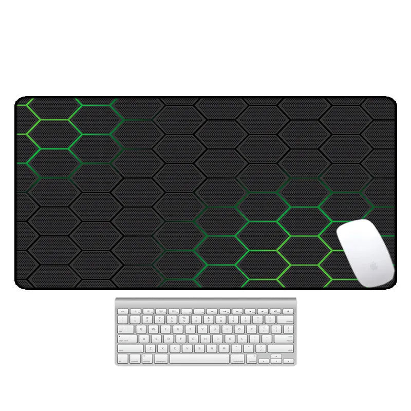 Large black rubber desk mouse pad with a printed geometric pattern, shown on a wooden desk.