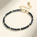 3mm blue tourmaline cut bead bracelet with spacer beads on a wrist
