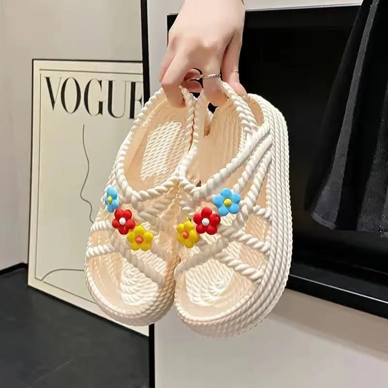 Beige PVC sandals with sunflower pattern and round toe on a non-slip sole.