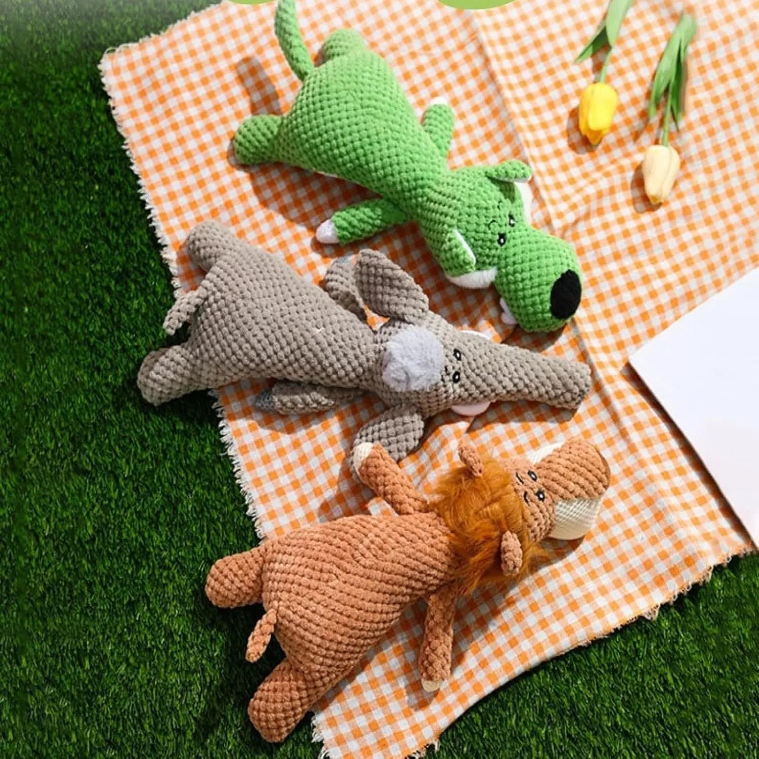 Interactive plush dog chew toy with corn kernel texture and squeaker in grey colour.