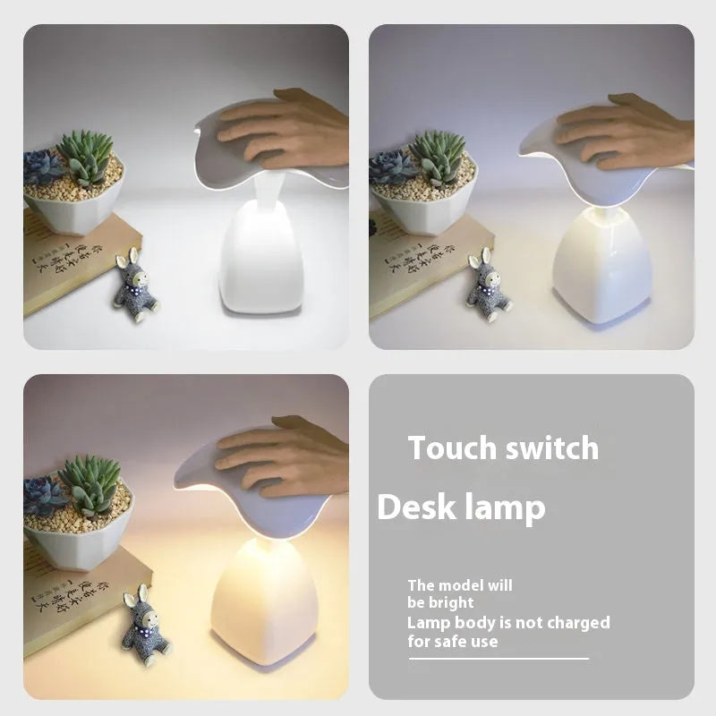 White modern plastic LED desk lamp with touch control on a wooden surface.