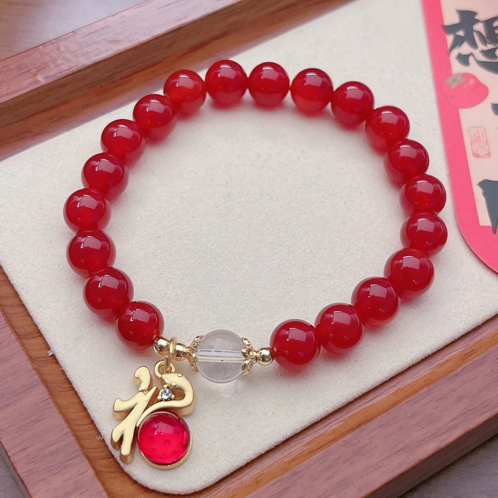 Handmade red agate bracelet with dragon and lucky bag Chinese designs for women.