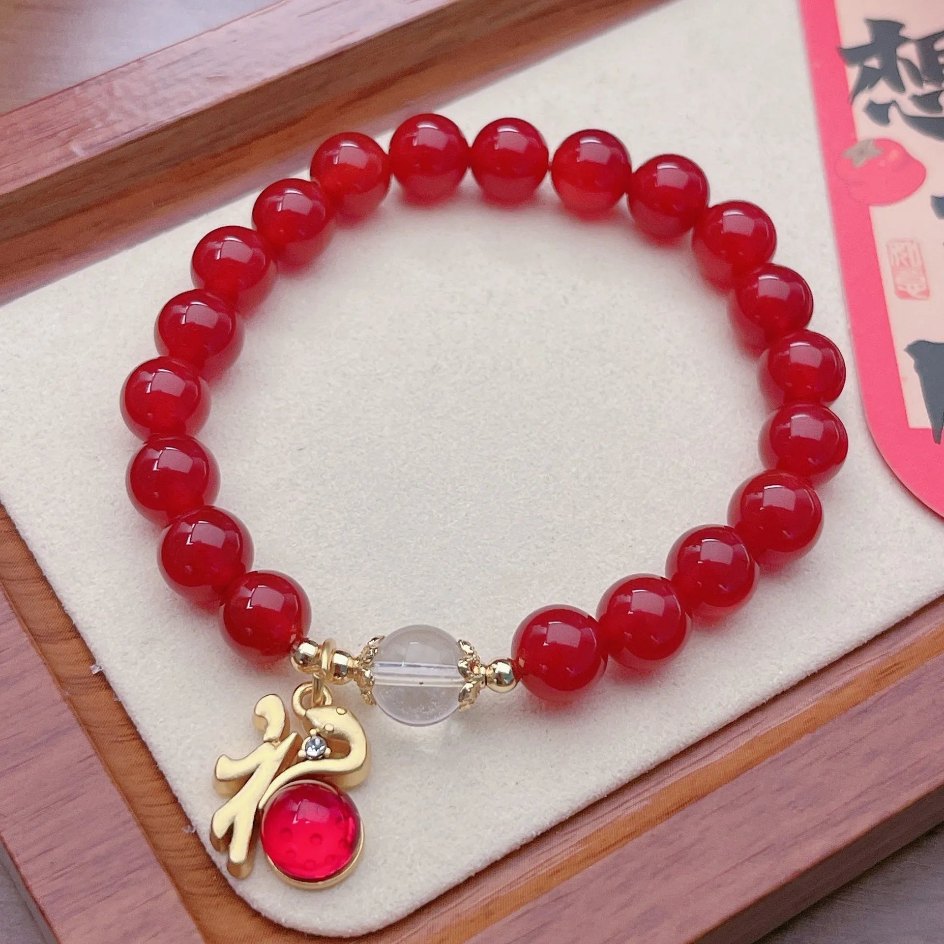Handmade red agate bracelet with dragon and lucky bag Chinese designs for women.